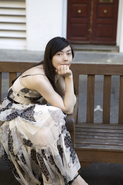 Pensive woman sitting on bench - Фото, изображение