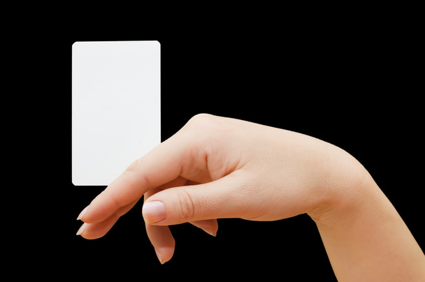 Paper card in woman hand on black background - Foto, imagen
