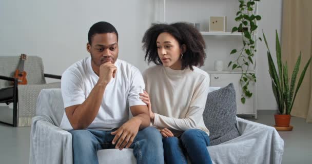Close up affectionate young afro american woman calms comforts beloved ethnic man showing love and care to sad husband. Worriend millennial girfriend giving psychological help to unhappy boyfriend - Footage, Video