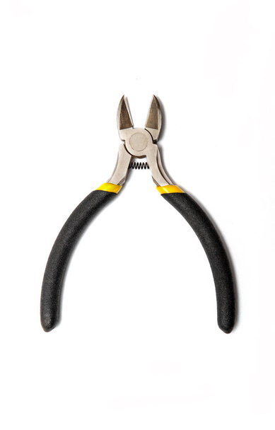 Diagonal pliers or wire cutters or diagonal cutting pliers or diagonal cutters with rubber handles for the master electrician on white background - Photo, Image