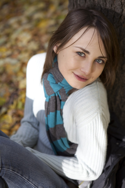 romantic brunette with golden autumn leaf close-up portrait - Фото, зображення