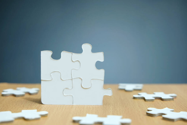 Conceptual photo of business strategy, four joined jigsaw puzzle with missing part - Foto, Imagen