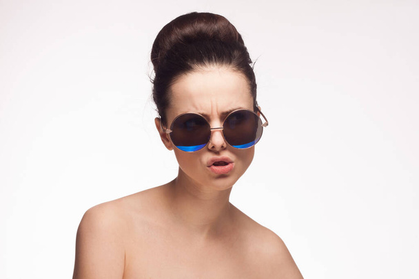 woman wearing sunglasses cropped view emotion light background - Photo, Image