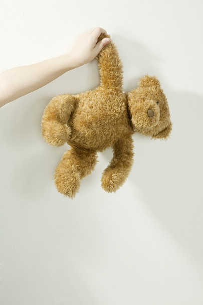 Child holding toy bear - Фото, зображення