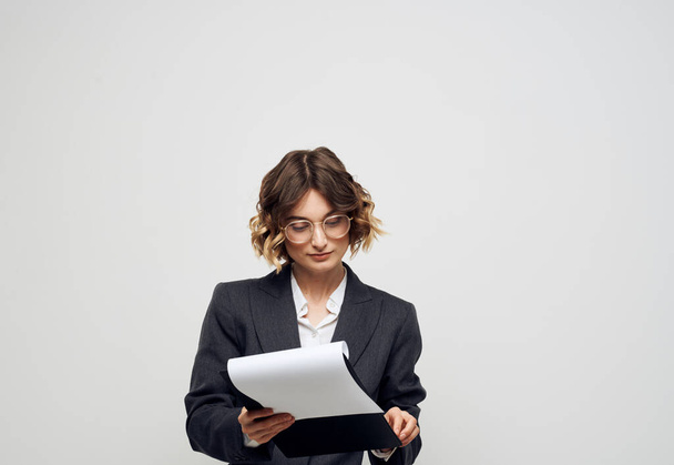 Business woman finance light background and documents in hands - Foto, imagen