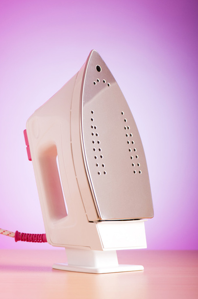 Modern electric iron against the colorful background - Photo, Image