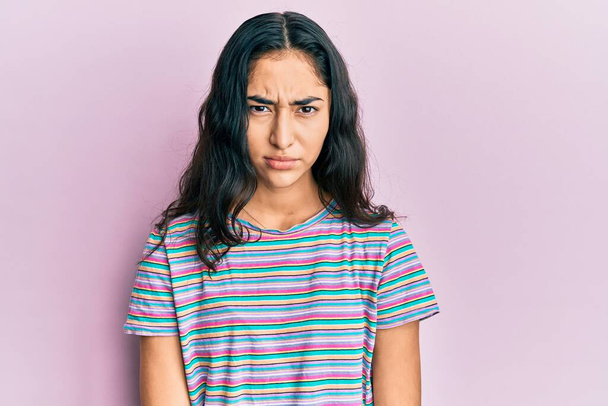 Hispanic teenager girl with dental braces wearing casual clothes skeptic and nervous, frowning upset because of problem. negative person.  - Photo, Image