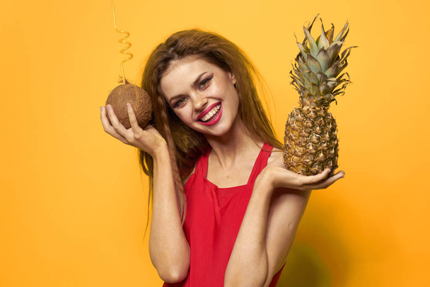 Pretty woman exotic fruits summer luxury yellow background - Photo, Image