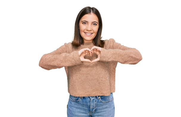 Young beautiful woman wearing casual clothes smiling in love doing heart symbol shape with hands. romantic concept.  - Photo, Image