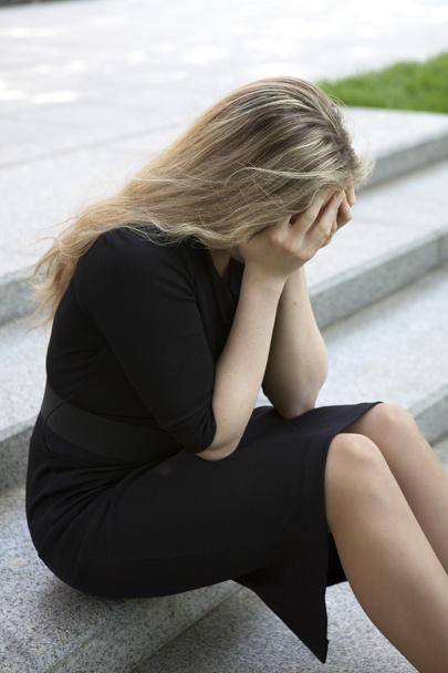 Depressed teen girl sitting on stairs  - Фото, зображення