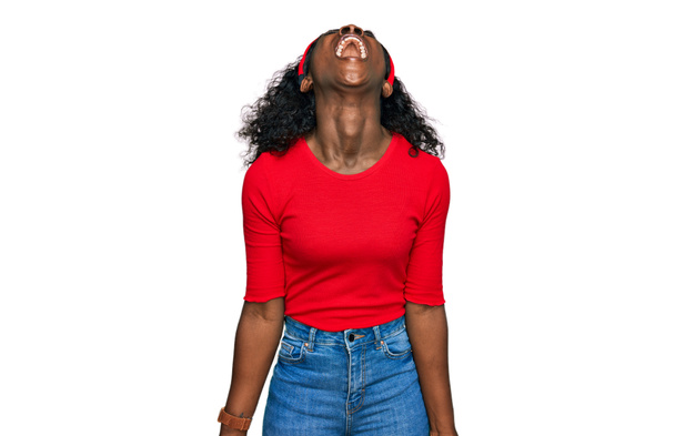 Beautiful african young woman wearing casual clothes angry and mad screaming frustrated and furious, shouting with anger. rage and aggressive concept.  - Photo, Image