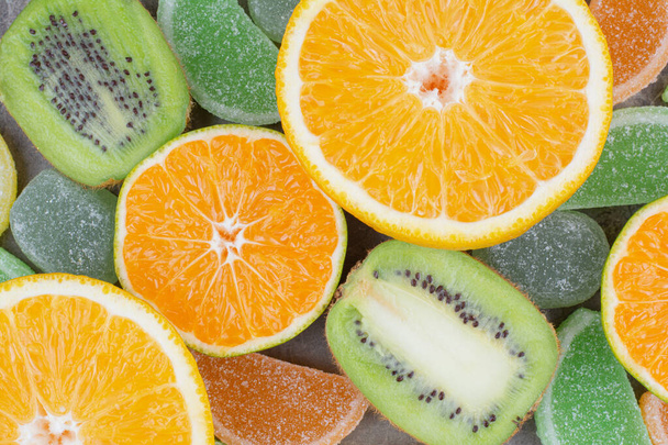 Свежие фрукты со сладкими мармеладами на мраморном фоне. Высокое качество фото - Фото, изображение