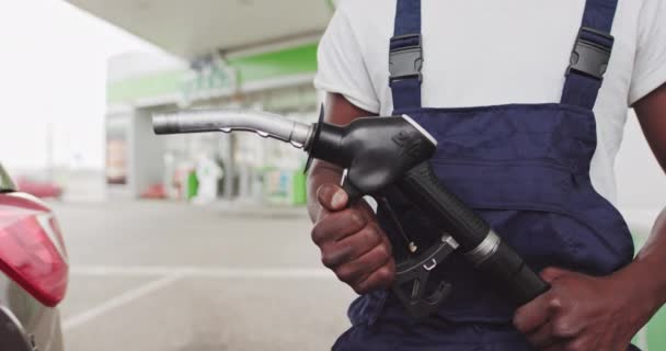 A Black African Refueling Worker Holds A Gun To Refuel A Car. Close-Up Of A Gun In The Hands Of A Black Worker. Gasoline, Gas, Petrol, Fuel, Petroleum Concept. - Footage, Video