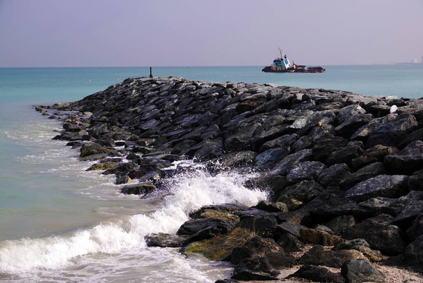 Vlnolamy z náspu obrovských kamenů na ochranu pláže před mořskou vlnou - Fotografie, Obrázek