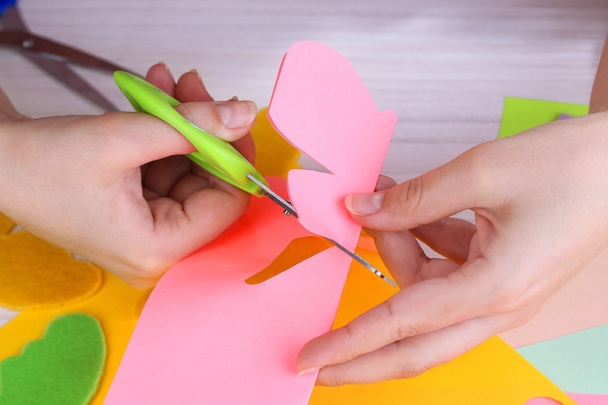 Women hand cutting colorful paper with scissors - Zdjęcie, obraz