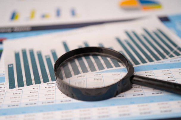 Magnifying glass on spreadsheet charts graphs paper. Financial development, Banking Account, Statistics, Investment Analytic research data economy, Stock exchange trading, Business office company meeting concept. - Photo, Image