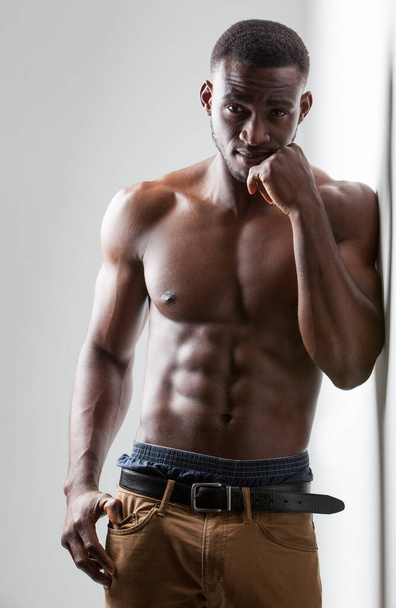 Dark Skinned Male Fitness Model on Light Background - Foto, imagen