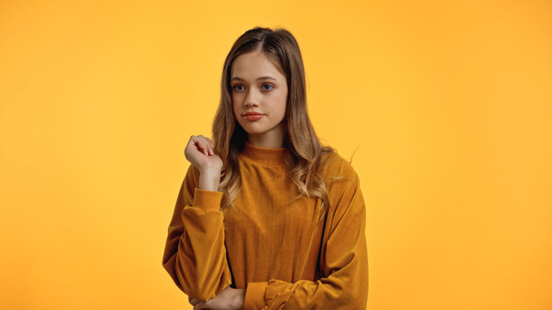 teenager in sweater looking away isolated on yellow - Фото, изображение