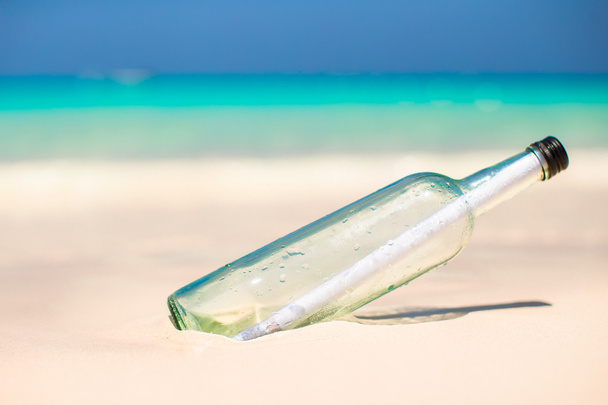 Bottle with a message buried in the white sand - Photo, Image
