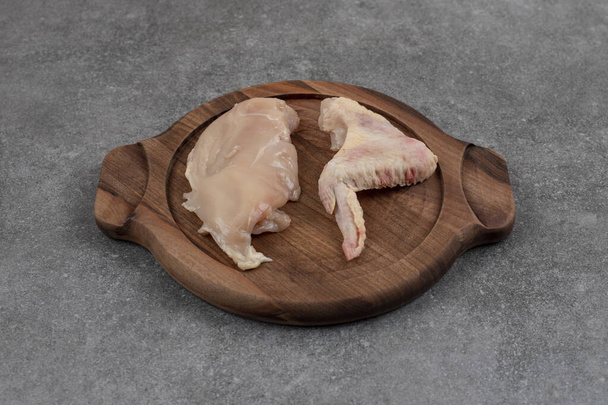 Raw organic chicken meats on wooden board . High quality photo - Photo, Image