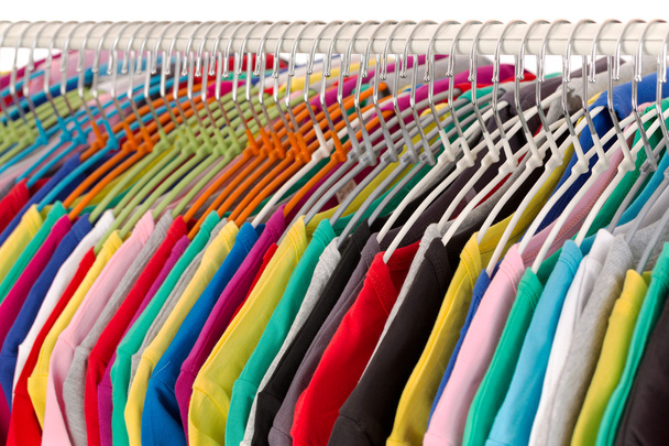 Colored shirts on hangers steel closeup. - Foto, afbeelding