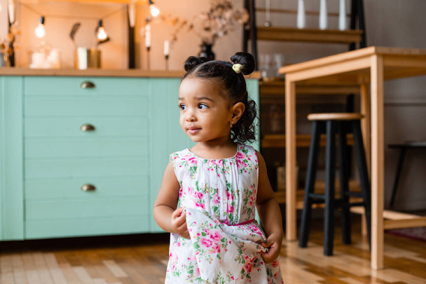 Cute little African American girl at home in kitchen - Photo, Image