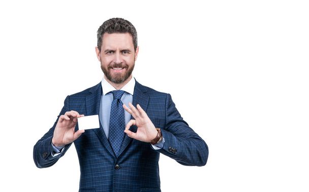 successful ceo suggest easy banking profit payment. handsome man show ok. happy boss isolated on white. copy space. businessman demonstrating credit or debit card. empty plastic business name card. - Photo, Image