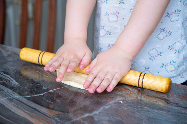 little girl rolls the dough - Photo, Image