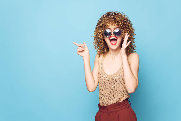 Woman portrait curly hair emotions fun gesture hands red lips wide open mouth  - Photo, image