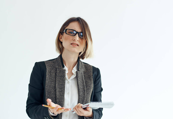 Cropped view of a business woman in a classic suit with documents on a light background - Photo, Image