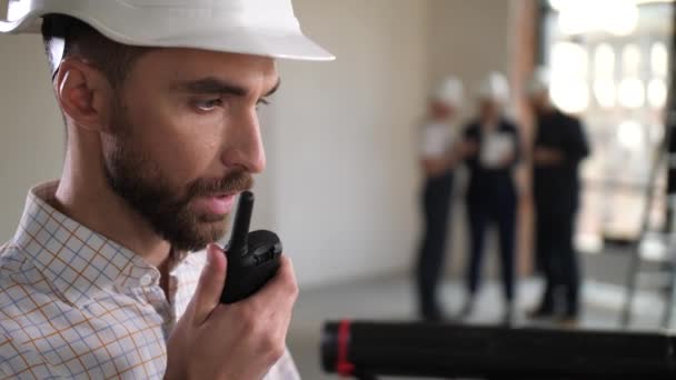 Portrait of architect talking walkie-talkie indoor - Footage, Video