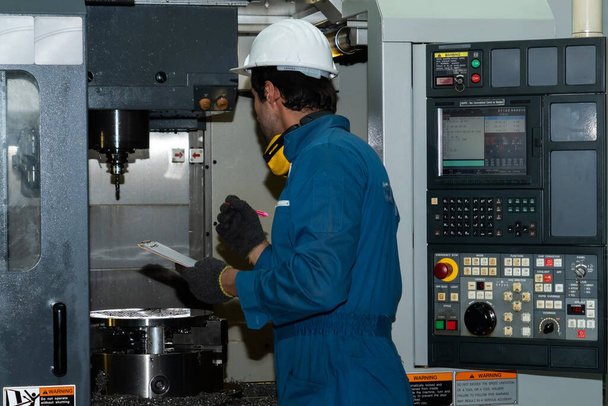 Smart factory worker or engineer do machine job in manufacturing workshop - 写真・画像