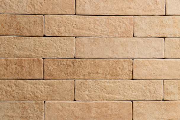 background of pale brown wall, made of natural bricks, top view - Фото, зображення