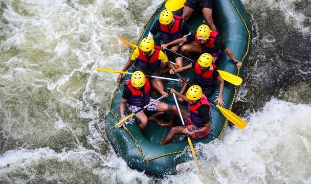 A group of men and women white water rafting - Photo, Image