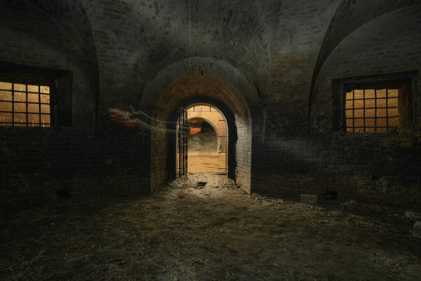 Dark interior of the old abandoned empty underground casemate flank of the Kyiv fortress of the 18th-19th centuries. - Photo, Image