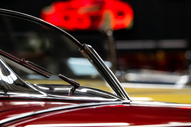 Red classic car windshield in a  gallery museum. - Fotó, kép