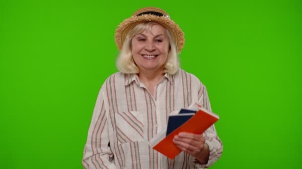 Ταξιδιώτρια τουρίστρια ηλικιωμένη γυναίκα που κατέχει εισιτήρια διαβατηρίου ονειρεύεται ποια χώρα να ξεκουραστεί στις διακοπές - Πλάνα, βίντεο