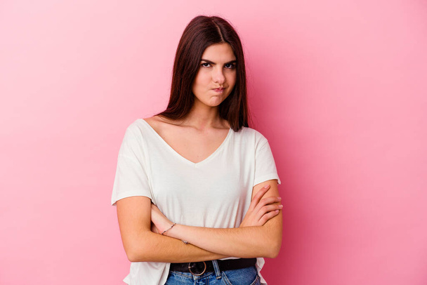 Young caucasian woman isolated on pink background blows cheeks, has tired expression. Facial expression concept. - Photo, Image