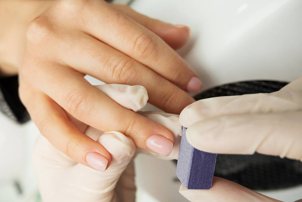 process of manicure and hand massage. clean fair skin, well-groomed manicure, unrecognizable people, selective focus - 写真・画像