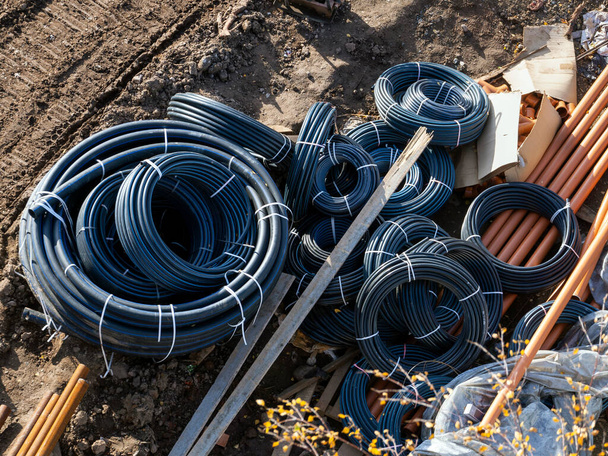 Electrical work on the laying of electrical cables. Rolls of cables and plastic pipes prepared for installation work. - Foto, immagini