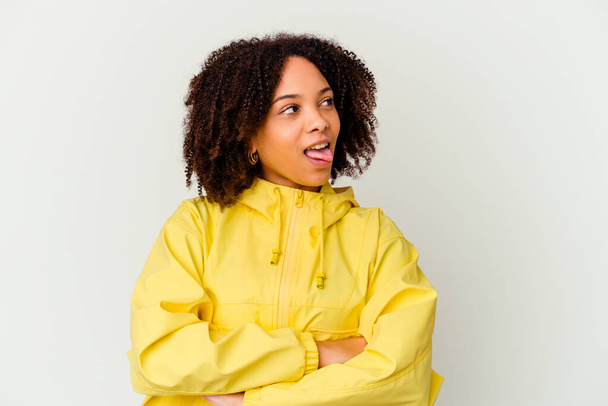 Young african american mixed race woman isolated funny and friendly sticking out tongue. - 写真・画像