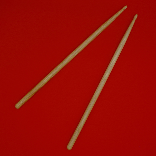 Percussion Drumsticks auf rotem Hintergrund. - Foto, Bild