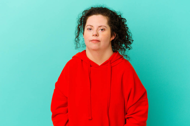 Woman with Down syndrome isolated shrugs shoulders and open eyes confused. - Photo, Image
