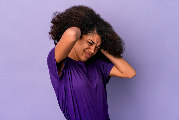Young african american curly woman isolated on purple background covering ears with hands. - Foto, Bild