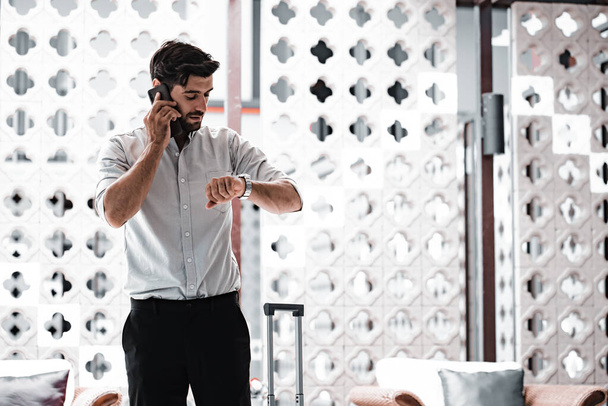 Handsome young bearded businessman with mobile phone - 写真・画像