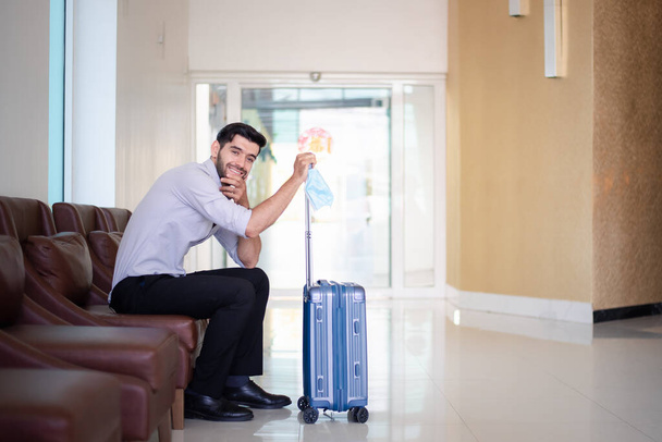 Handsome young bearded businessman with suitcase  - Foto, imagen