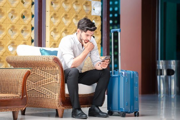 Handsome young bearded businessman with mobile phone - 写真・画像