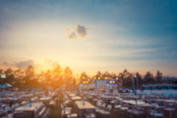 vintage tone blur image of tables and decoration prepared for an outdoor anniversary party on evening time for background usage. - Fotoğraf, Görsel
