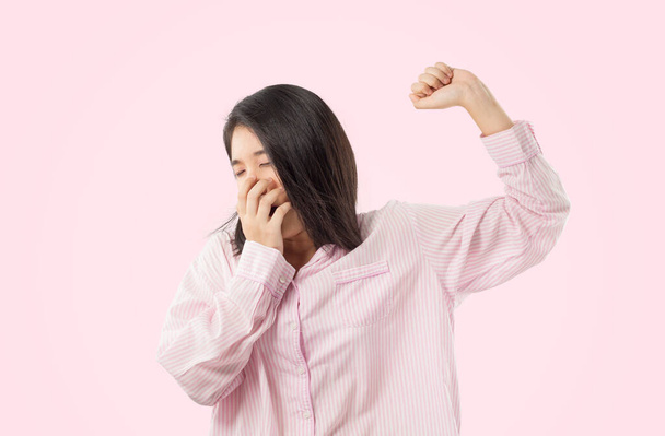 woman wear pink pajamas yawn and stretch when her wake up feeling sleepy	 - Photo, Image