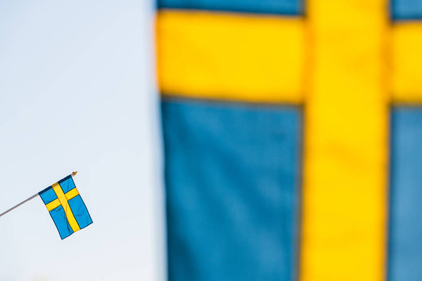 Swedish flag behind another flag - Photo, Image